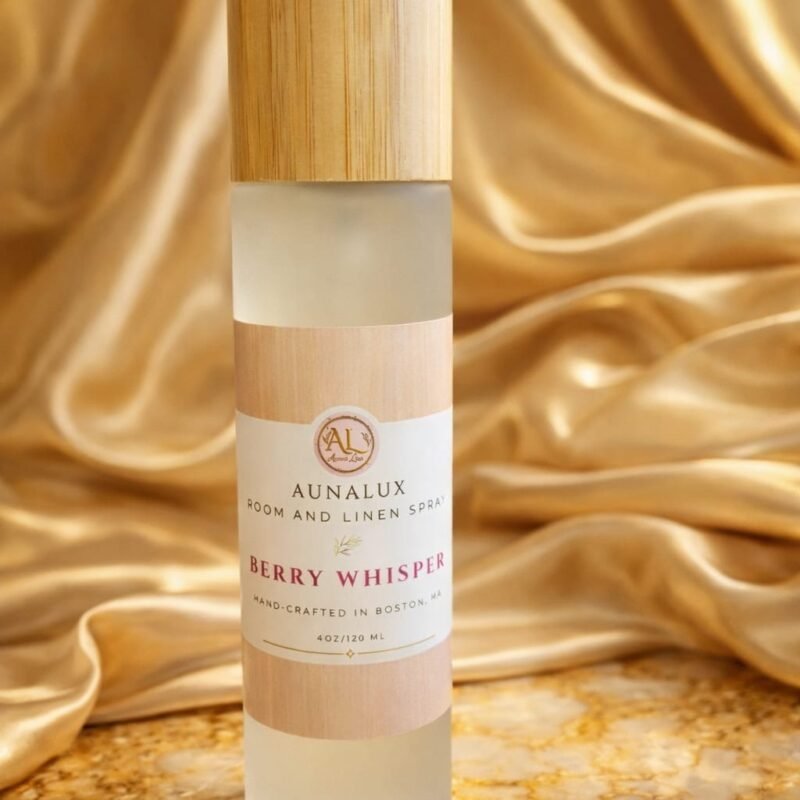 AunaLux Berry Whisper room and linen spray in frosted glass bottle with wooden cap on gold satin background
